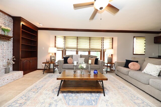 carpeted living room featuring ceiling fan, ornamental molding, a fireplace, and brick wall