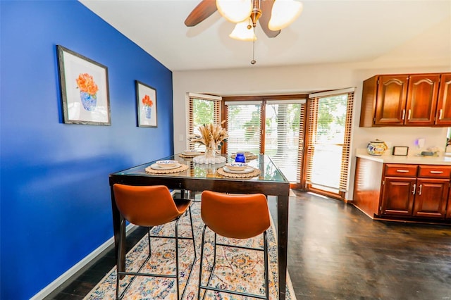 dining area with ceiling fan and dark hardwood / wood-style floors