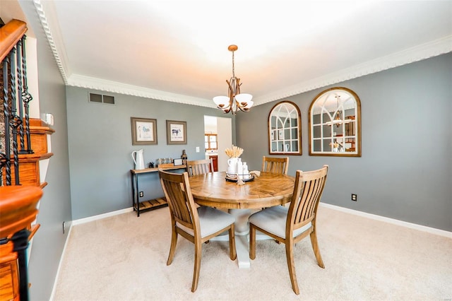 carpeted dining area featuring an inviting chandelier and crown molding