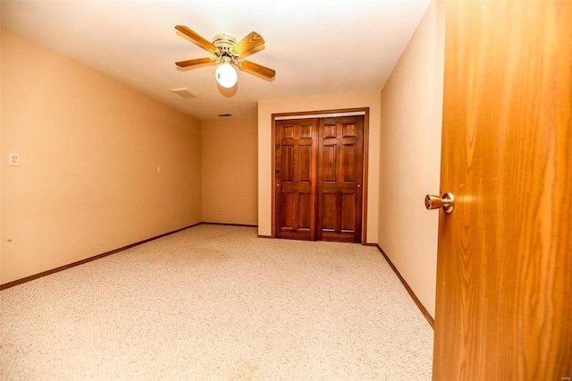 unfurnished bedroom featuring carpet floors and ceiling fan