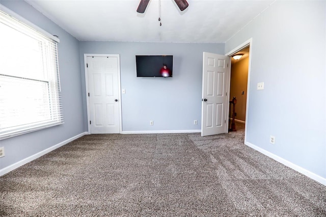 unfurnished bedroom featuring carpet floors and ceiling fan