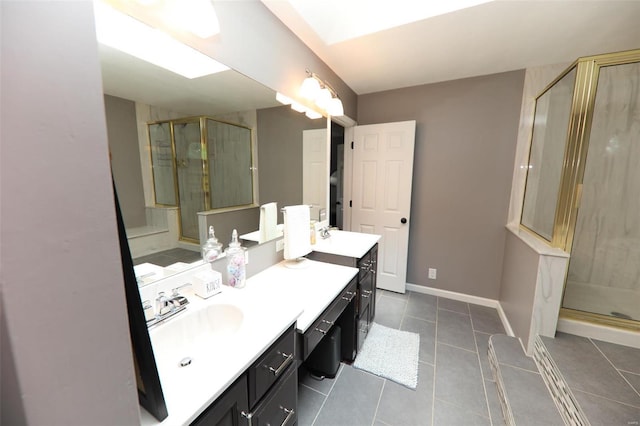 bathroom with a shower with door, tile patterned flooring, and vanity