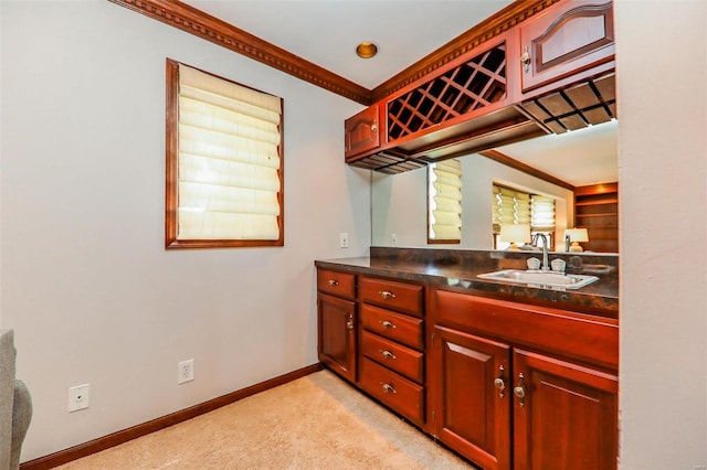 kitchen featuring sink, crown molding, and light colored carpet