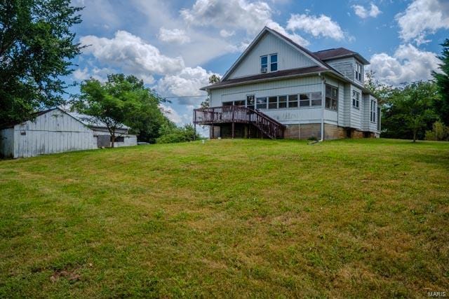 back of house featuring a yard and a deck