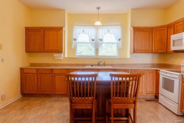 kitchen featuring light tile patterned floors, sink, and white appliances