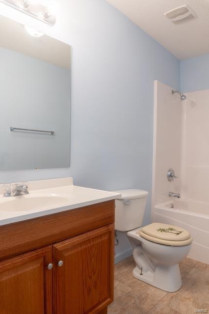 full bathroom featuring toilet, vanity, bathtub / shower combination, and tile patterned floors