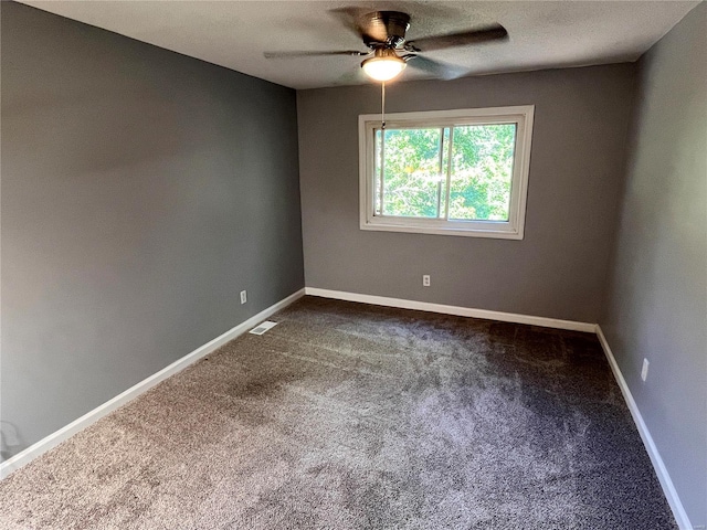 spare room featuring ceiling fan and carpet