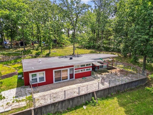 rear view of property featuring a patio area and a lawn