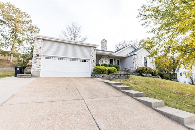 view of front of house featuring a front lawn and a garage