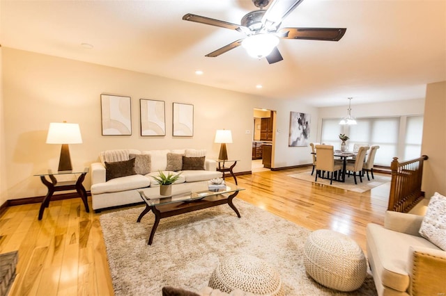 living room with light wood-type flooring and ceiling fan