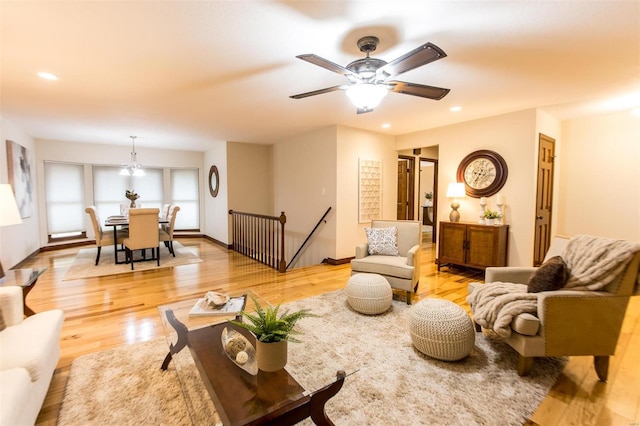 living room with hardwood / wood-style flooring and ceiling fan