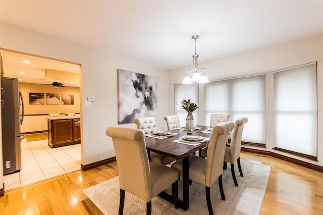 dining area featuring light hardwood / wood-style floors and a chandelier