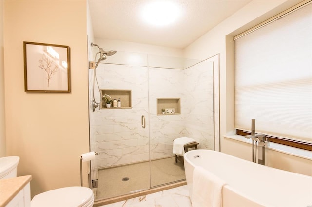 full bathroom featuring vanity, shower with separate bathtub, and toilet