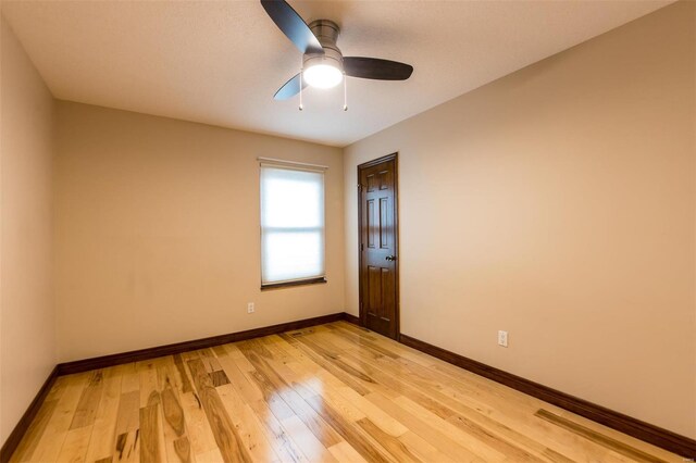 empty room featuring light wood-type flooring and ceiling fan