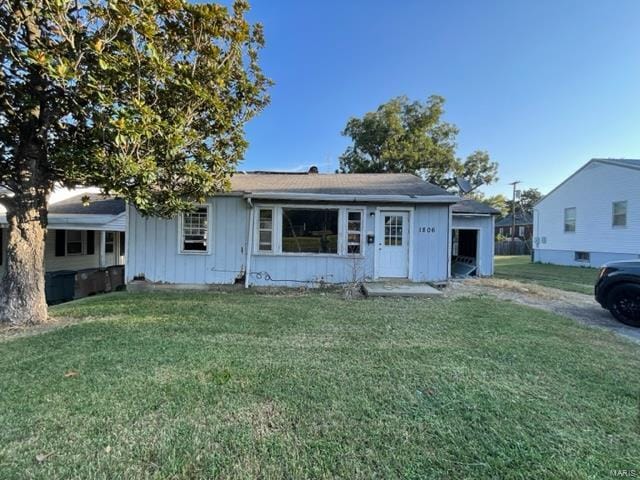 view of front facade featuring board and batten siding and a front yard