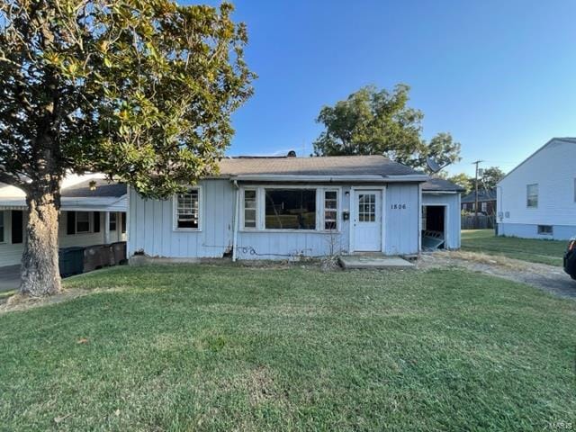 view of front of house with a front lawn and board and batten siding