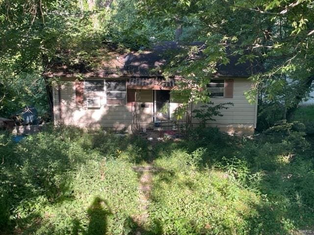 view of property hidden behind natural elements