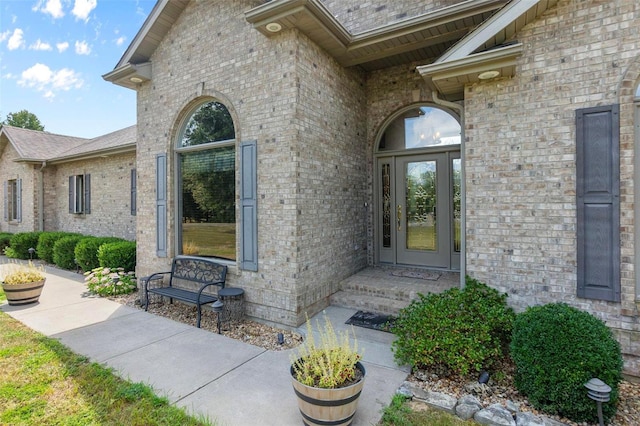 view of exterior entry with brick siding