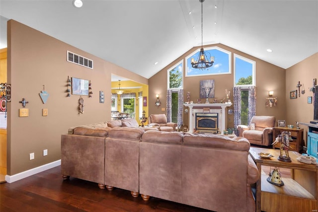 living room featuring baseboards, visible vents, lofted ceiling, a premium fireplace, and dark wood-type flooring