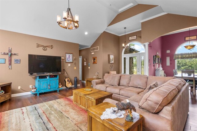 living room with lofted ceiling, a chandelier, ornamental molding, and dark hardwood / wood-style floors