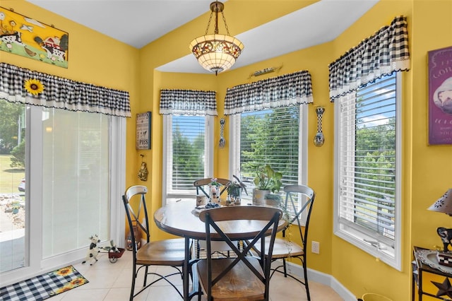 dining space with light tile patterned floors and baseboards