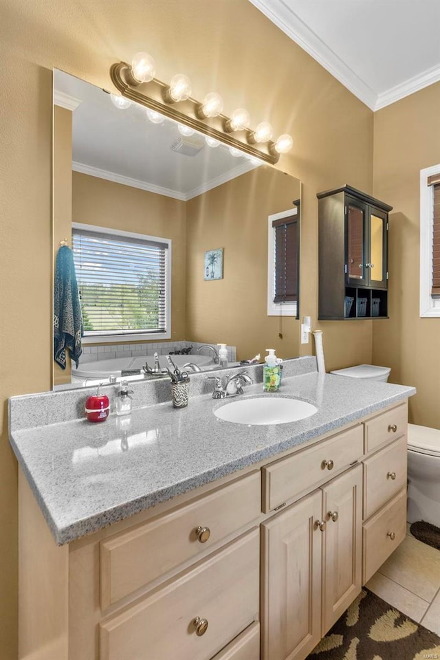 bathroom with toilet, crown molding, vanity, and tile patterned floors