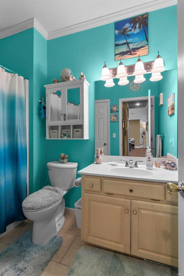 bathroom featuring tile patterned flooring, toilet, vanity, and ornamental molding