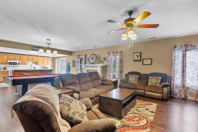 living room with ceiling fan, hardwood / wood-style flooring, and pool table