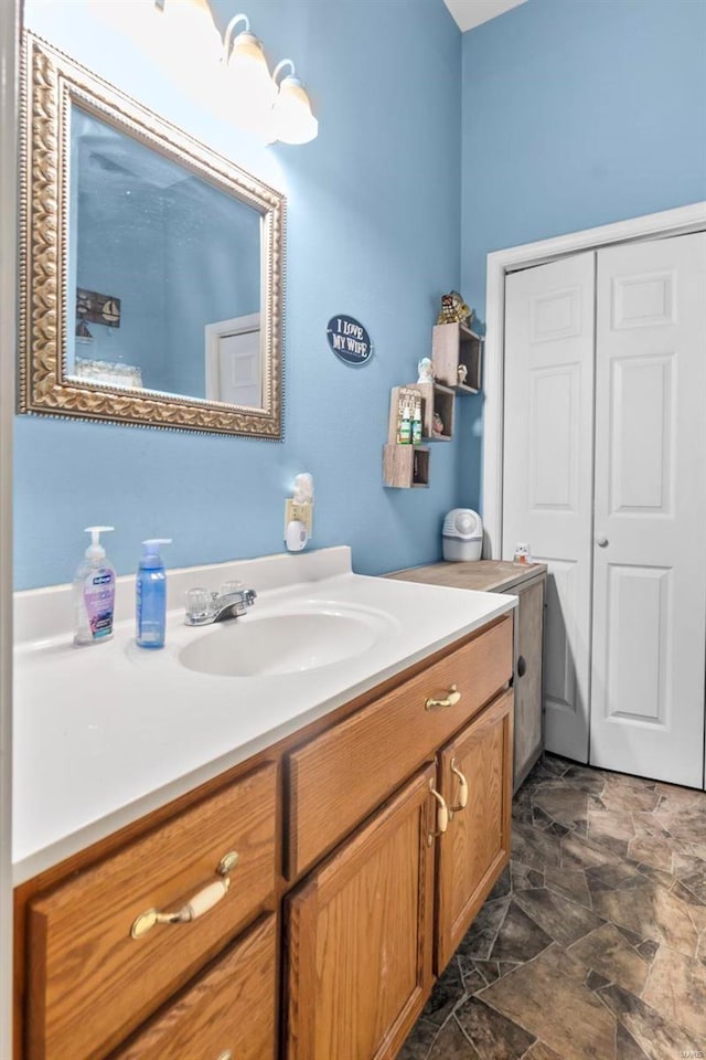 bathroom with toilet, tile patterned flooring, and vanity