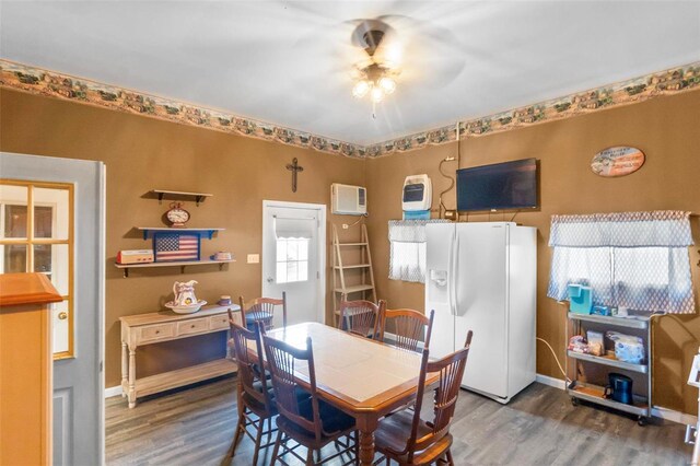 dining area with ceiling fan and dark hardwood / wood-style flooring