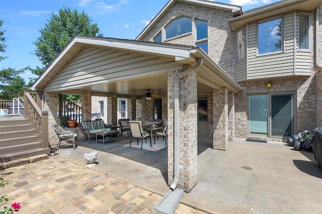 view of patio / terrace featuring stairs, ceiling fan, and outdoor dining space