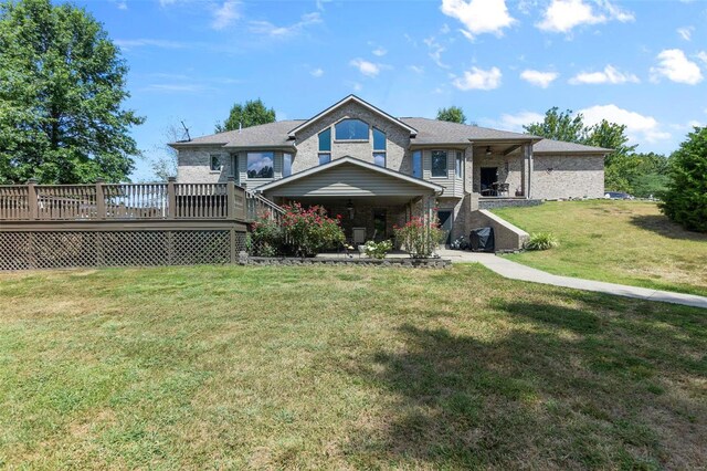 view of front of house featuring a wooden deck and a front yard