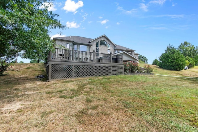 back of house with a wooden deck and a lawn