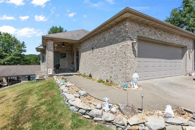 ranch-style house featuring a garage, a front yard, concrete driveway, and brick siding