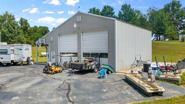 view of outbuilding featuring a garage and a yard