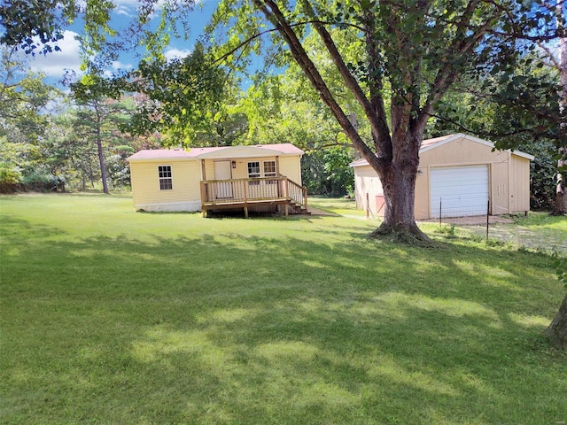 view of yard with an outbuilding, a detached garage, and a wooden deck