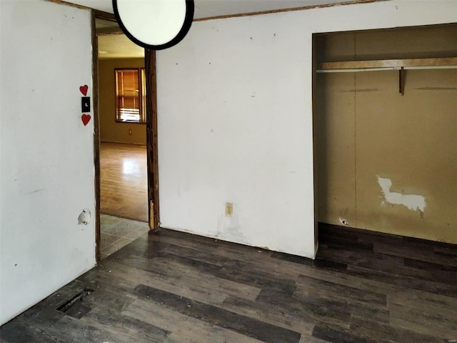 unfurnished bedroom with dark wood-style flooring