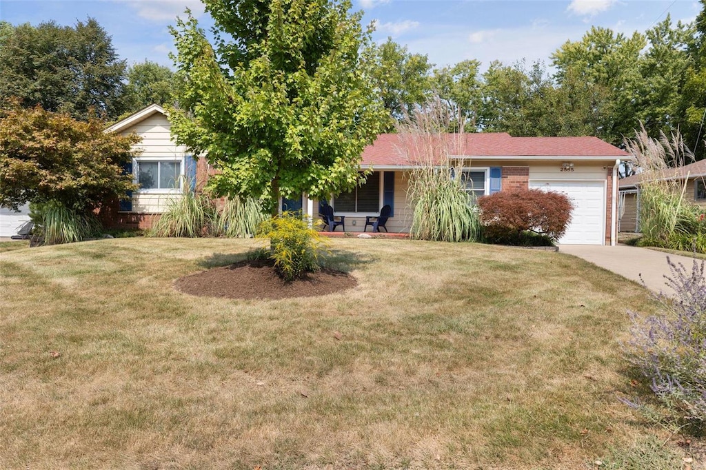 view of front of home with a garage and a front lawn