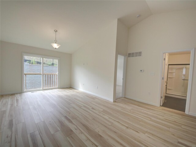 interior space with light hardwood / wood-style flooring and high vaulted ceiling