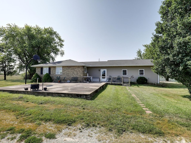 back of property featuring a yard, a patio area, and a deck