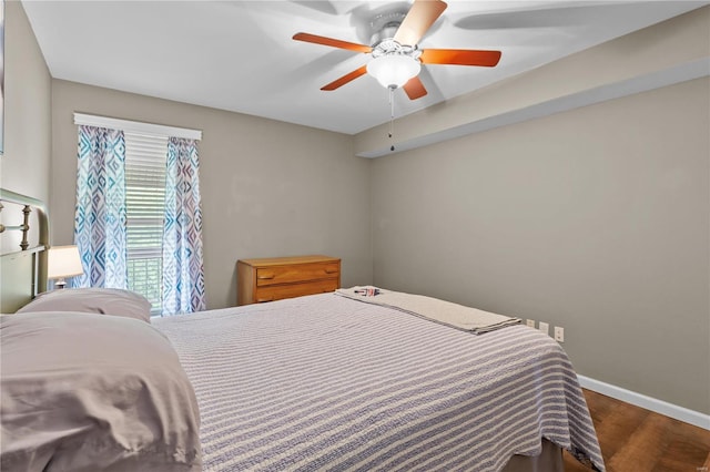 bedroom featuring ceiling fan and dark hardwood / wood-style flooring