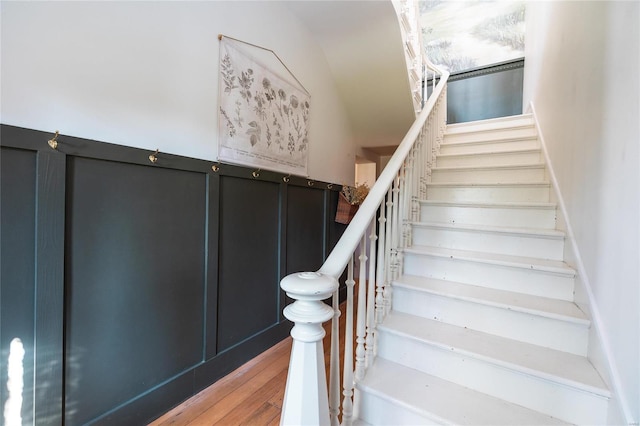 stairway with hardwood / wood-style flooring