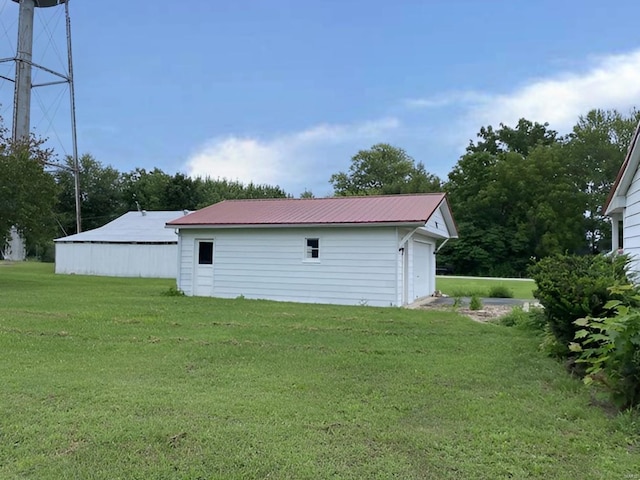 exterior space with a garage and an outbuilding