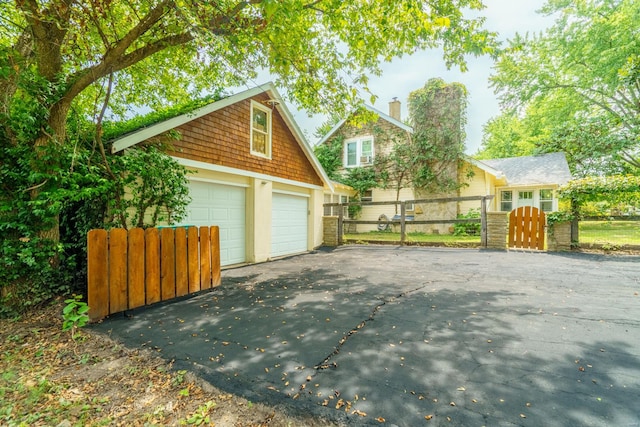 view of property exterior with a garage and an outdoor structure