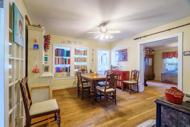 dining area featuring light wood-type flooring and ceiling fan