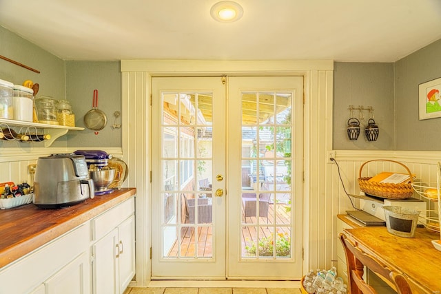 doorway with light tile patterned floors and french doors