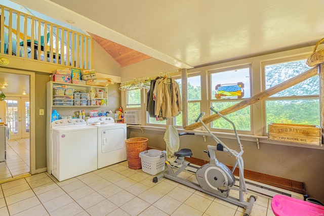 laundry area with independent washer and dryer and light tile patterned floors