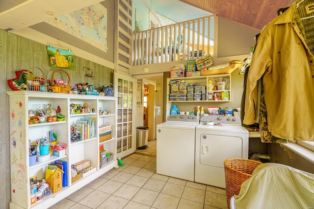 laundry room featuring washing machine and dryer, a towering ceiling, light tile patterned floors, and wooden ceiling