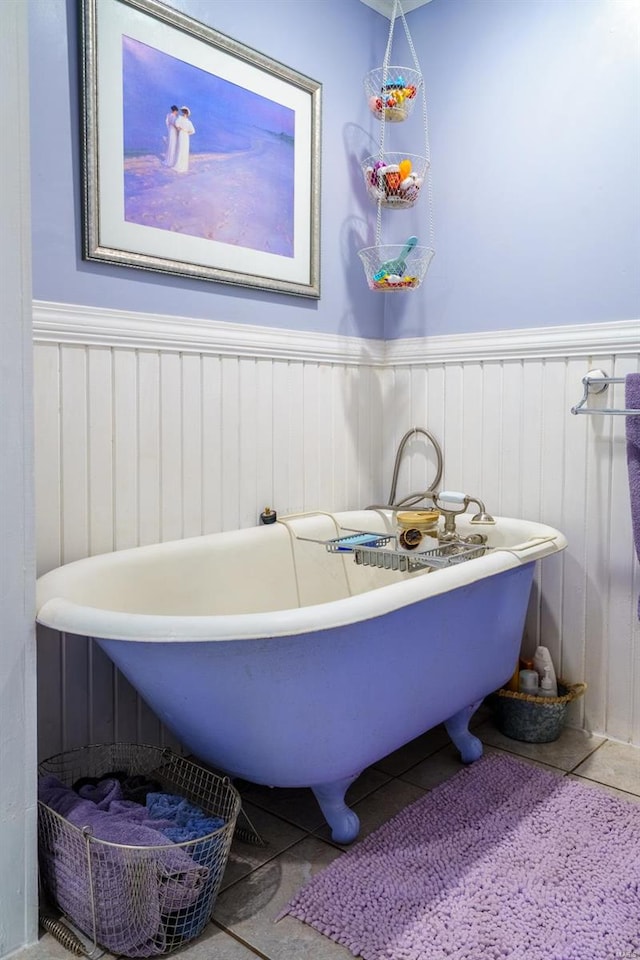 bathroom with a bathing tub and tile patterned flooring