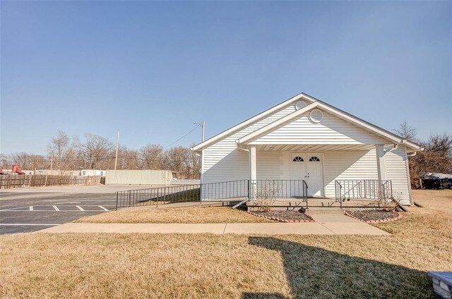 exterior space with a porch and a lawn